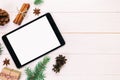 Digital tablet mock up with rustic Christmas wooden background decorations for app presentation. top view vintage, toned with copy Royalty Free Stock Photo