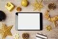 Digital tablet mock up template with Christmas decorations on wooden background. View form above