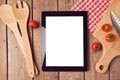 Digital tablet mock up template with cooking utensils and tomatoes. View from above Royalty Free Stock Photo