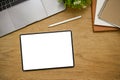 Digital tablet mockup is on wooden tabletop background with office supplies. top view Royalty Free Stock Photo