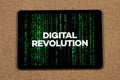 a digital tablet with the phrase digital revolution over a green digital code and a cork background Royalty Free Stock Photo