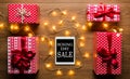 Digital tablet, presents and christmas lights, retro Boxing Day Sale concept Royalty Free Stock Photo
