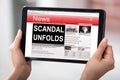 Digital Tablet With A Screen Showing Unfolds Scandal News Royalty Free Stock Photo