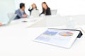 Digital tablet showing data chart on screen at business meeting Royalty Free Stock Photo