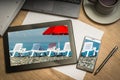 Digital tablet with sunbathing beds and red umbrella on screen Royalty Free Stock Photo