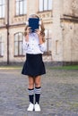 Digital technologies for learning. Elearning and modern methods. Girl cute schoolgirl hold book and headphones