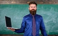 Digital technology education. Teacher bearded man with modern laptop chalkboard background. Online education. Modern