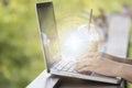 Digital technology over laptop with hand typing on keyboard nature background Royalty Free Stock Photo