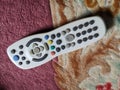 A digital television remote control on a carpet. Royalty Free Stock Photo