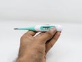 a digital thermometer with Low reading, in the hands of a person Royalty Free Stock Photo