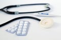 Stethoscope and pills isolated on a white background Royalty Free Stock Photo