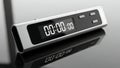 Digital timer device with zeroed time on reflective black surface Royalty Free Stock Photo