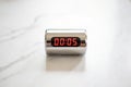 Digital timer displays five seconds on a modern marble surface Royalty Free Stock Photo