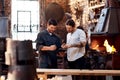 These digital tools are so useful. two handsome young using a digital tablet while working together inside their Royalty Free Stock Photo