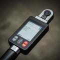 Digital torque wrench with a rectangular screen displaying measurements. The device Royalty Free Stock Photo