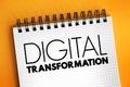 Digital transformation - adoption of digital technology by a company, text concept on notepad Royalty Free Stock Photo