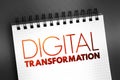 Digital transformation - adoption of digital technology by a company, text concept on notepad