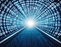 Digital tunnel with glowing binary code leading to bright light at the end Royalty Free Stock Photo