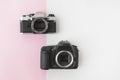 Digital versus Analog SLR Camera on Pink Background with Copyspace Royalty Free Stock Photo