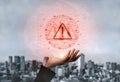 Digital Warning Alert on Hand Against Urban Background with Binary Code Graphic, Symbolizing Cybersecurity and Data Royalty Free Stock Photo