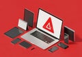 Digital warning alert on laptop screen surrounded by various electronic devices in a vibrant red setting symbolizing cybersecurity Royalty Free Stock Photo