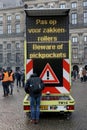 Digital warning sign against pickpockets on Dam Square in Amsterdam