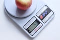 Digital weights scale is showing the numerical weight of weighing fruit.