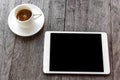 Digital white tablet and coffee cup