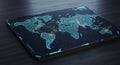A digital world map displayed on a sleek tablet surface. Glowing cyan outlines Royalty Free Stock Photo