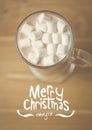 Digitally composite image of merry christmas message against a cup of hot chocolate Royalty Free Stock Photo