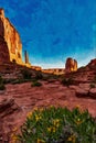 Digitally created watercolor painting of Park Avenue Trailhead with yellow flowers in Arches National Park, Moab, Utah