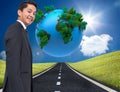Digitally generated earth floating over street Royalty Free Stock Photo