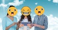Digitally generated image of friends faces covered with emoji using digital tablet and smart phone a Royalty Free Stock Photo