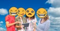 Digitally generated image of friends faces covered with emoji using digital tablet and smart phone a Royalty Free Stock Photo