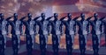 Digitally generated image of male military soldiers saluting side by side against america flag
