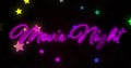 Digitally generated image of movie night neon text and multi colored stars moving against black back Royalty Free Stock Photo
