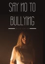 Digitally generated image of say no to bullying text over woman against black background