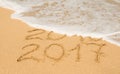 Digits 2016 and 2017 on the sand Royalty Free Stock Photo