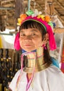 Dignified elderly Karen long-neck woman wears traditional brass neck coils and poses in