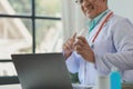 A dignified middle-aged male doctor was sitting in his private office at the hospital, Doctors are sitting and working in various