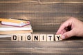 Dignity business concept. Wooden letters on the office desk