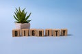 Dignity word written on wood block on blue