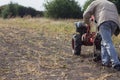 DIKANKA, UKRAINE - SEPTEMBER 30, 2015: Country farmer is plowing his garden with walk-behind garden tractor. Royalty Free Stock Photo