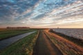 The dike around the island of Marken during sunrise with the lighthouse Het Paard van Marken in the background Royalty Free Stock Photo