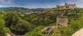 A dilapidate tower contrasts with the fortress across the gorge in Spoleto, Italy