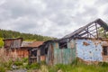 A dilapidated abandoned house in the countryside. There are signs of fire, desolation and old junk Royalty Free Stock Photo