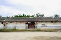 Dilapidated ancient Chinese dwelling house against cloudy sky Royalty Free Stock Photo