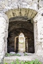 Dilapidated ancient synagogue. View of the old structure through the arched window. The texture of the old dilapidated masonry. Royalty Free Stock Photo