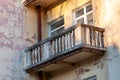 Dilapidated balcony on the old shabby facade