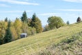 Dilapidated barn and haystack on a hill Royalty Free Stock Photo